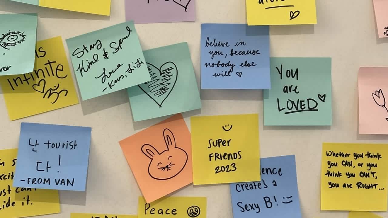 colourful sticky notes with affirmations written on them posted on a wall