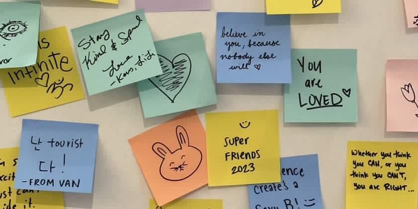 colourful sticky notes with affirmations written on them posted on a wall