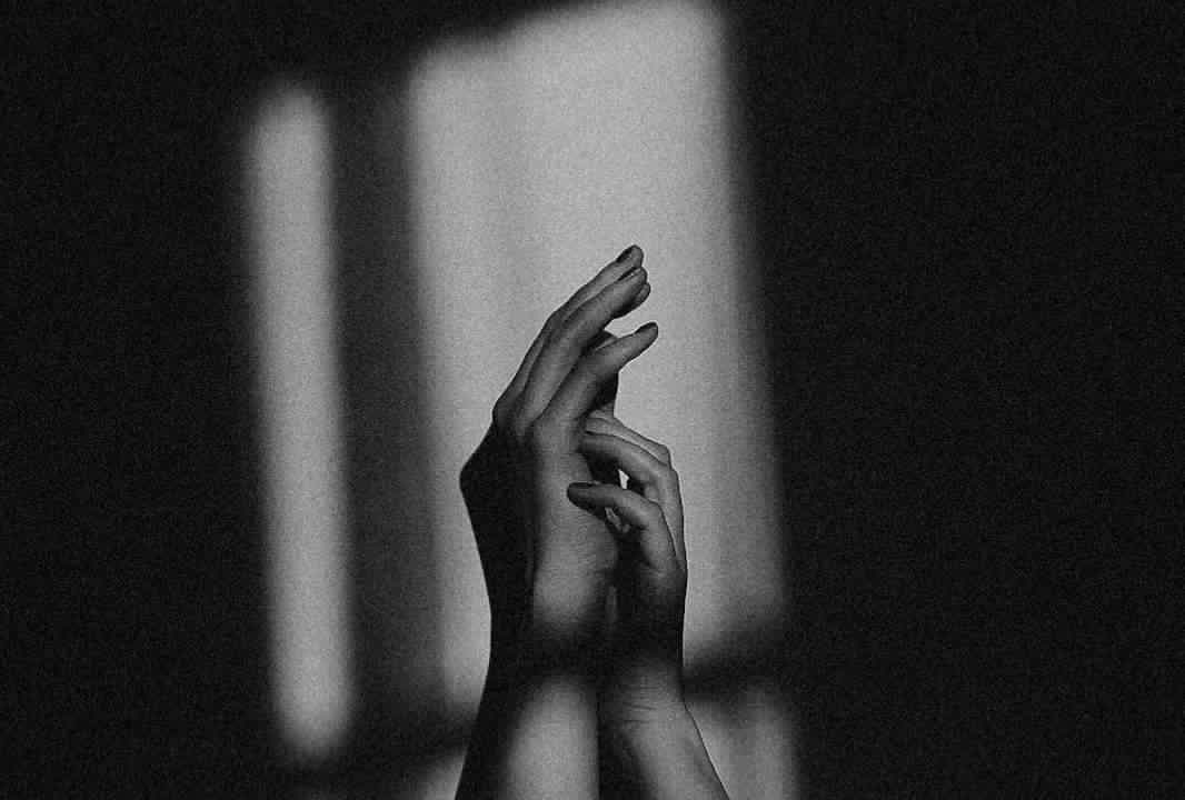 Dark image of two hands