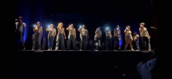 A group of people preforming on a stage